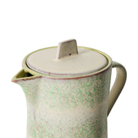 Close-up of the 70s Ceramics teapot's lid, spout and handle detail, showing the sculpted tab handle and mottled glaze