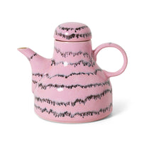 Pink teapot with black pattern on a white background