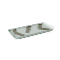 Angled view of the HKLIVING Tide cake tray in green stoneware, highlighting its raised rim and brushstroke pattern