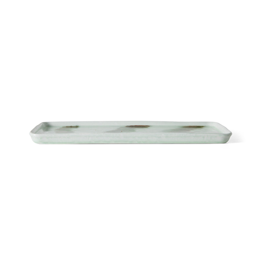 Side profile view of the HKLIVING Tide cake tray in green stoneware, showing its low, flat rim