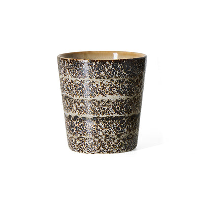 An hklvig 70s ceramic Brew coffee cup with a textured, speckled glaze in dark brown, black, and beige, featuring horizontal bands, shown on a plain white background.