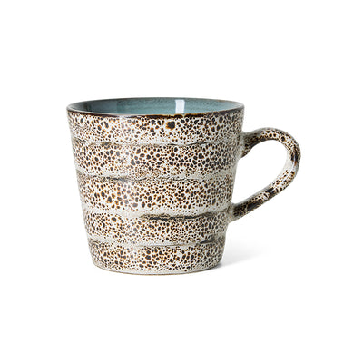 A hkliving 70s ceramic Brew coffee mug with a speckled brown and beige enamel pattern, a light blue interior, and a thick handle, shown on a white background.