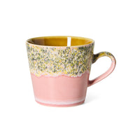 An HKLIVING 70s ceramic Macaron coffee mug with a two-tone design, featuring a textured green and yellow floral pattern on the upper half and a matte dusty pink lower half, set against a plain white background.