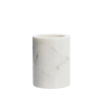 white round marble jar on white background showing natural veining
