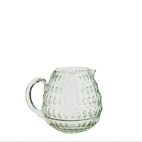 clear glass jug with dotted texture and curved handle

