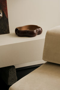 Lagoon large glass dish by Olsson & Jensen on a white shelf beside a sofa