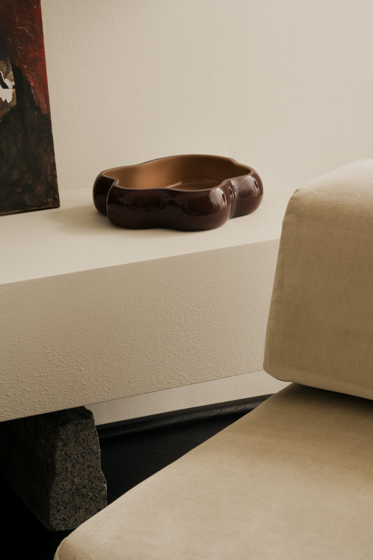 Lagoon large glass dish by Olsson & Jensen on a white shelf beside a sofa