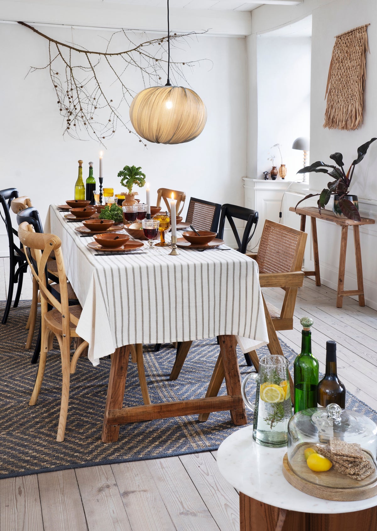large glass dome with wooden base styled on dining table in cosy nordic home