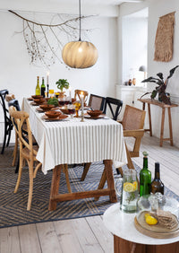 large glass dome with wooden base styled on dining table in cosy nordic home