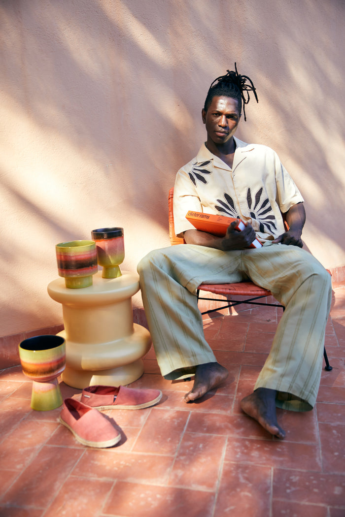 hkliving flower pots styled with books, a guy in a summer look sandals