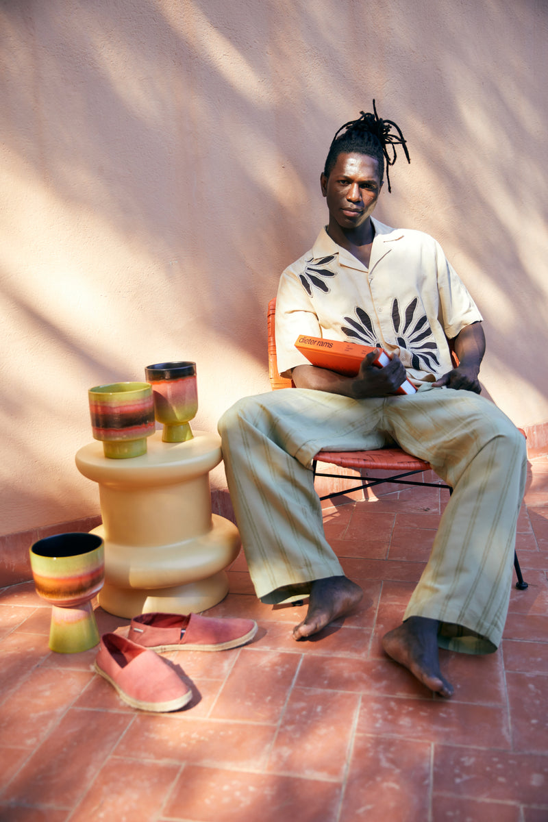 hkliving flower pots styled with books, a guy in a summer look sandals