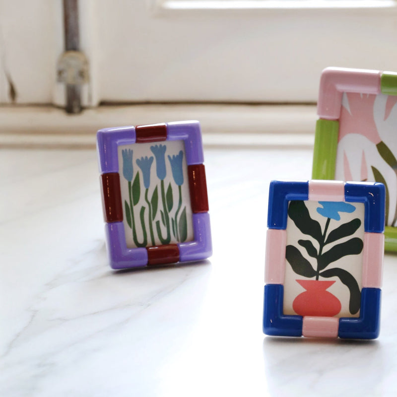 Rift Rectangle Lilac frame with glossy lilac segments and rust-red blocks by &Klevering.

