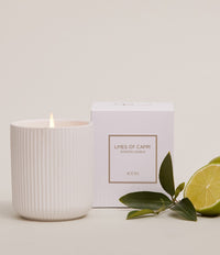 Limes of Capri citrus scented candle in white ceramic vessel with gift box and fresh limes