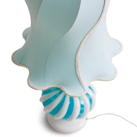 angled down view of the celeste lamp from hk living in white and light blue adding a decorative flair to a space