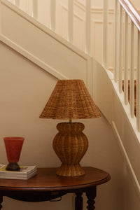 Lolli dusty rose vase by Olsson & Jensen on a hallway table beside a rattan lamp
