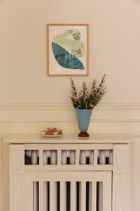 Lolli light blue vase by Olsson & Jensen with dried flowers on a white cabinet