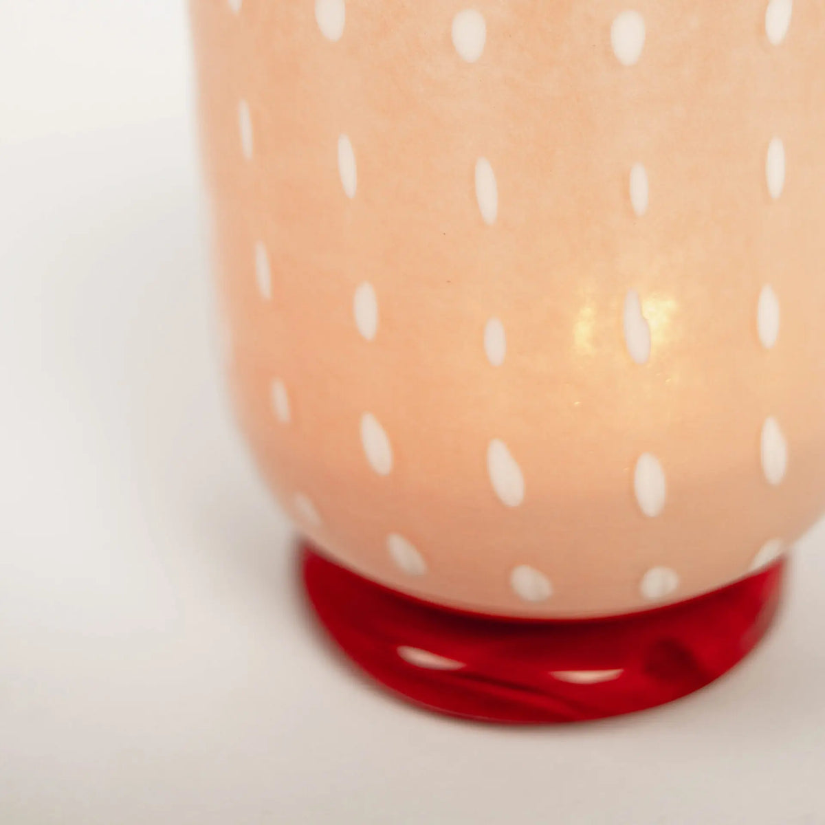Close-up of the white dots and red base on the Lolo pink tealight holder by Olsson & Jensen