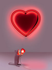 Seletti Pink Mouse Lamp beneath a glowing red neon heart