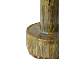 Close-up of a ceramic vase with a textured surface on a white background