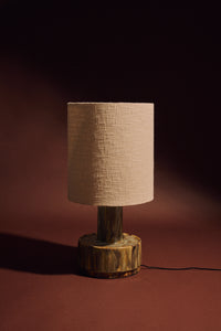 Ceramic lamp base in reactive green glaze on white background, base only