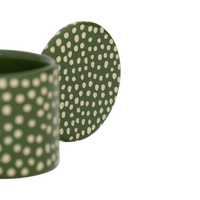 Close-up of the Lucan tealight holder's round handle and cream dots
