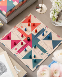 Open Ludo board in play with colourful pieces