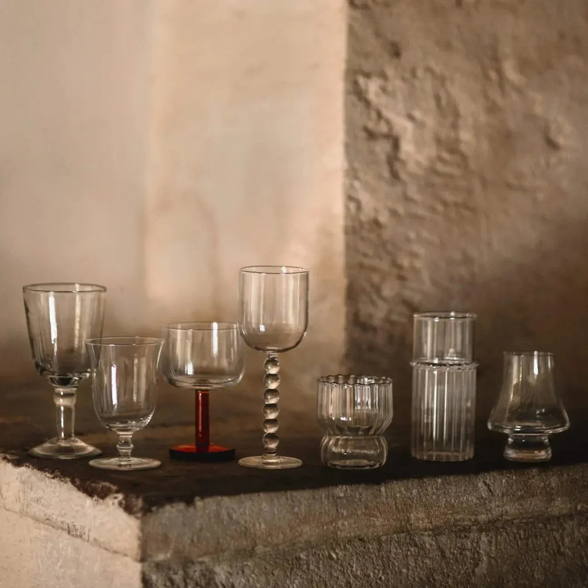 Luna wine glasses and glassware by Olsson & Jensen styled on a stone ledge