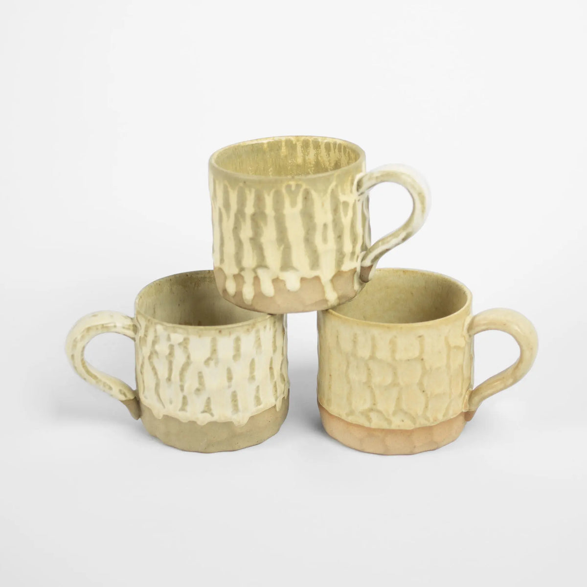 Three stacked beige Maja mugs by Olsson & Jensen