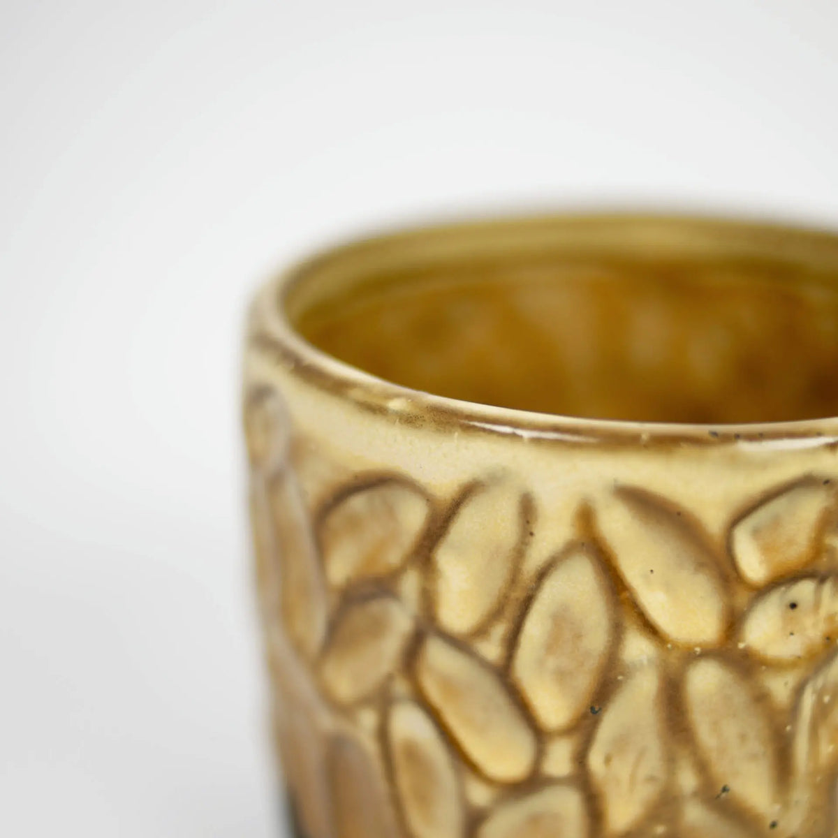 Close-up of the carved pattern on the mustard Maja mug by Olsson & Jensen