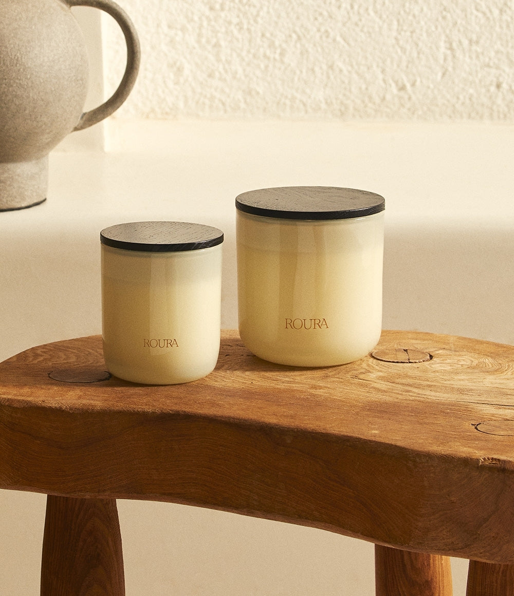 Majestic Lotus scented candles in two sizes with cream glass vessels and black lids