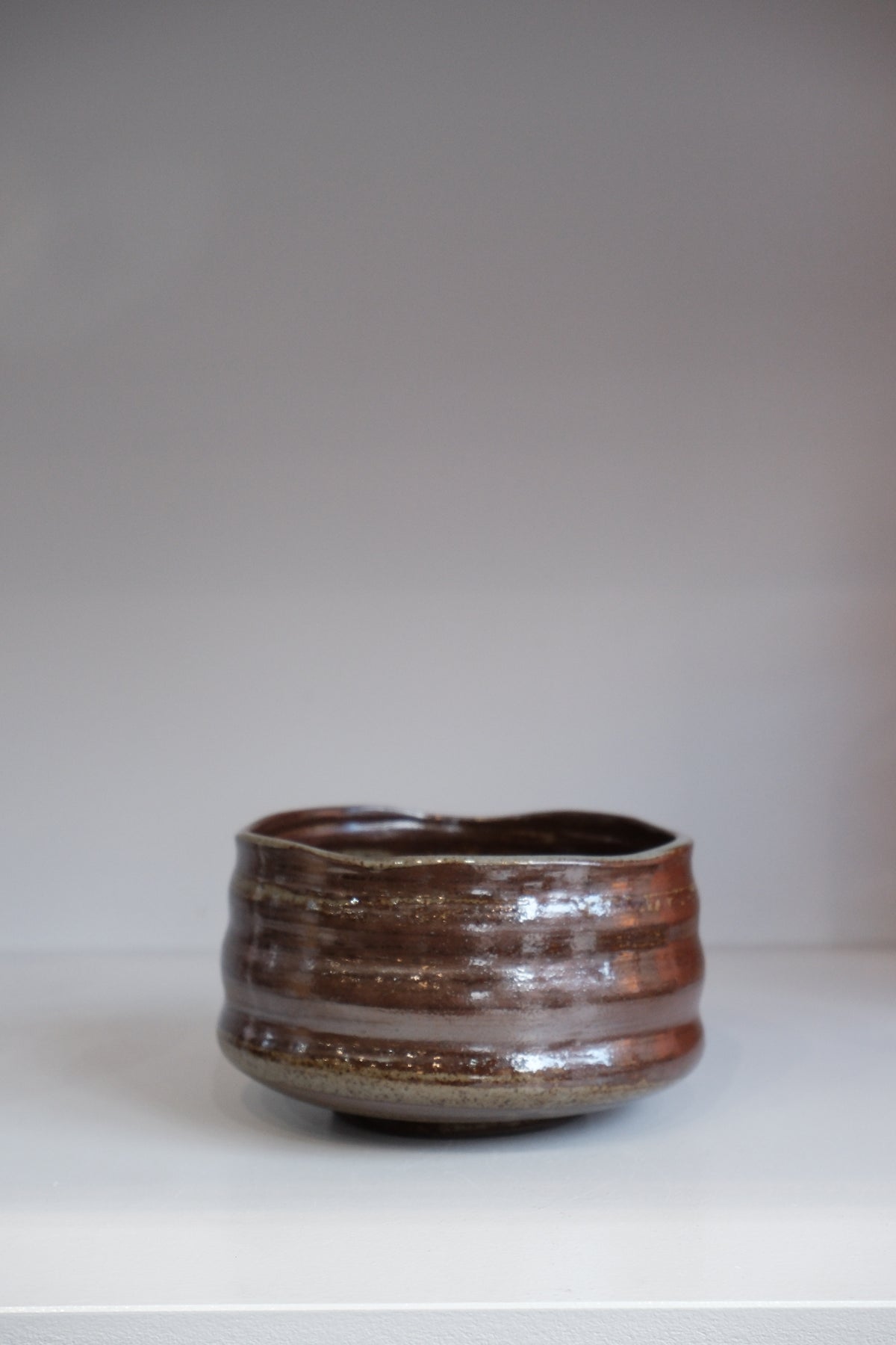 handmade bark matcha bowl with brown and grey speckled glaze
