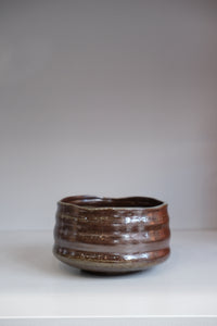 handmade bark matcha bowl with brown and grey speckled glaze
