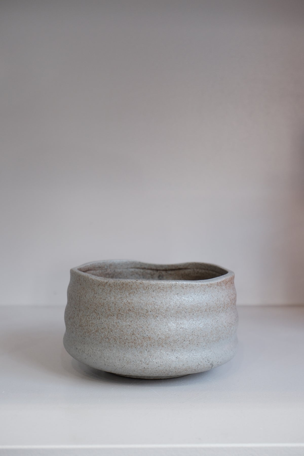 handmade pebble matcha bowl in grey stoneware with subtle brown speckling