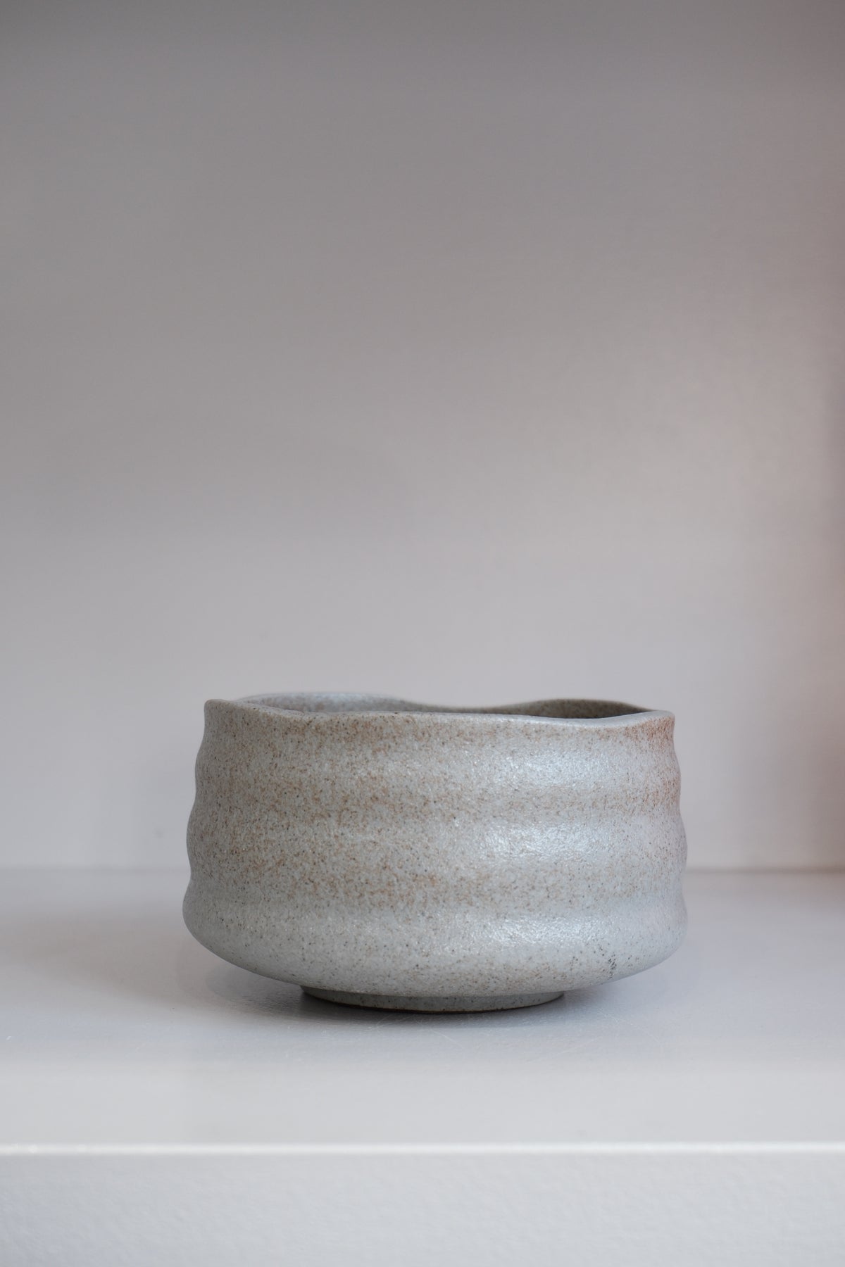 grey stoneware matcha bowl showing brown speckles and organic handmade texture
