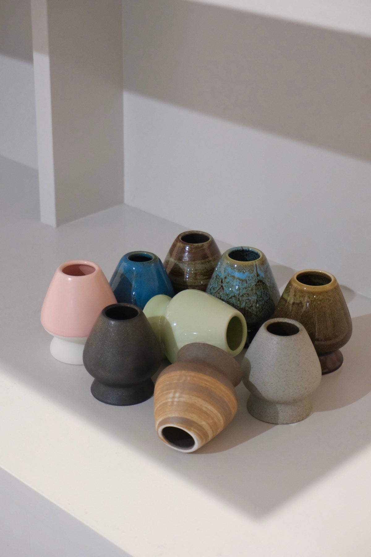 ceramic chasen naoshi matcha whisk stands in multiple colours including auburn
