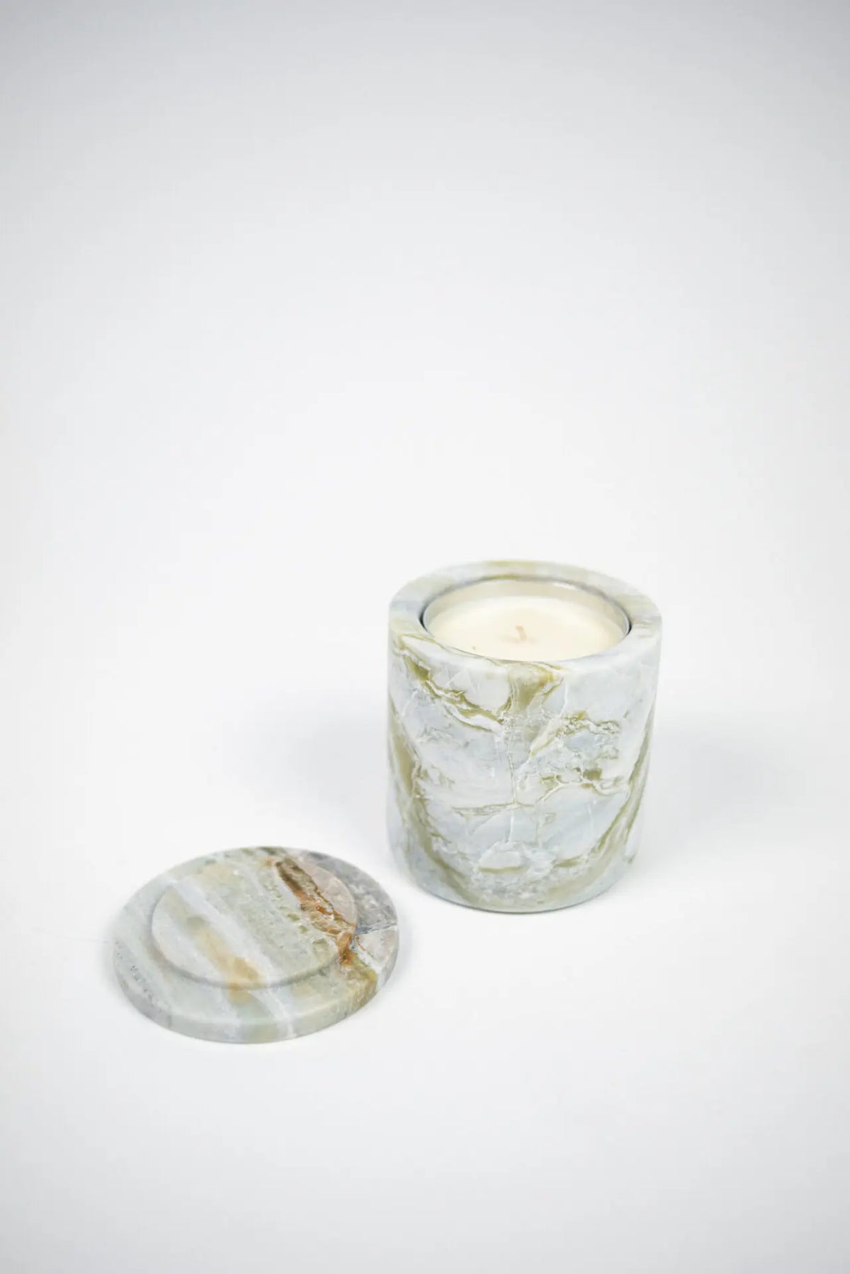 Mauro green marble scented candle with the lid removed by Olsson & Jensen