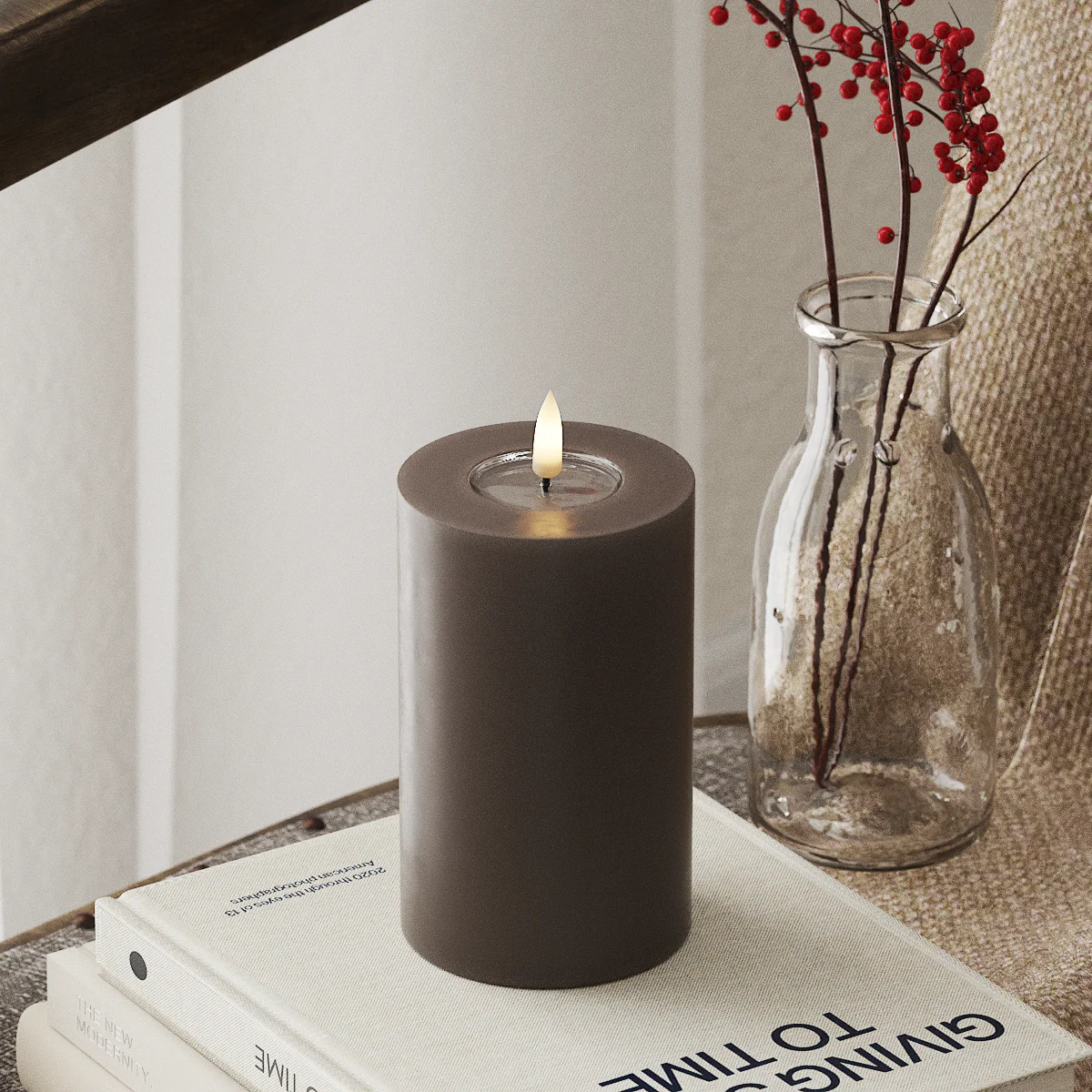 mocha LED candle glowing warmly in a soft winter home styling scene
