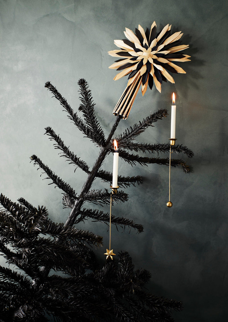 brass christmas tree candle holders clipped onto branches with lit white candles
