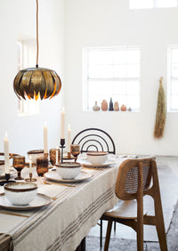 speckled stoneware dinner plates styled on a Scandinavian dining table
