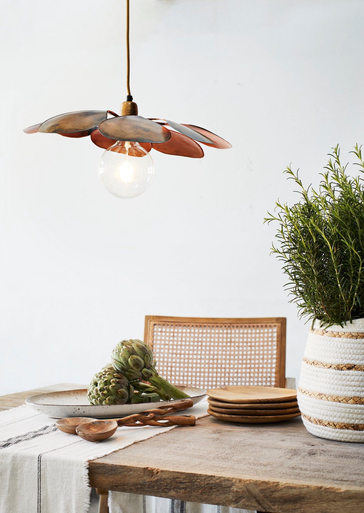 oval stoneware serving dish styled on dining table with wooden cutlery and natural textures
