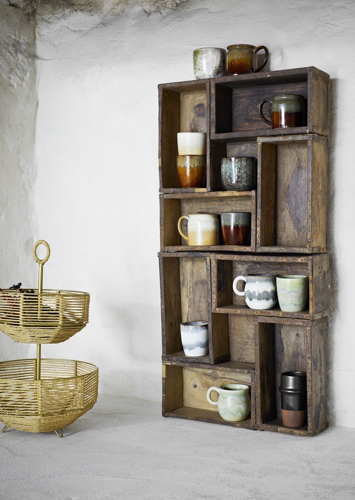 reactive glaze stoneware mugs in white and green displayed on a rustic shelf for Nordic style
