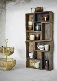 reactive glaze stoneware mugs in white and green displayed on a rustic shelf for Nordic style

