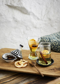 small mango wood spoon styled beside warm drinks on a wooden tray
