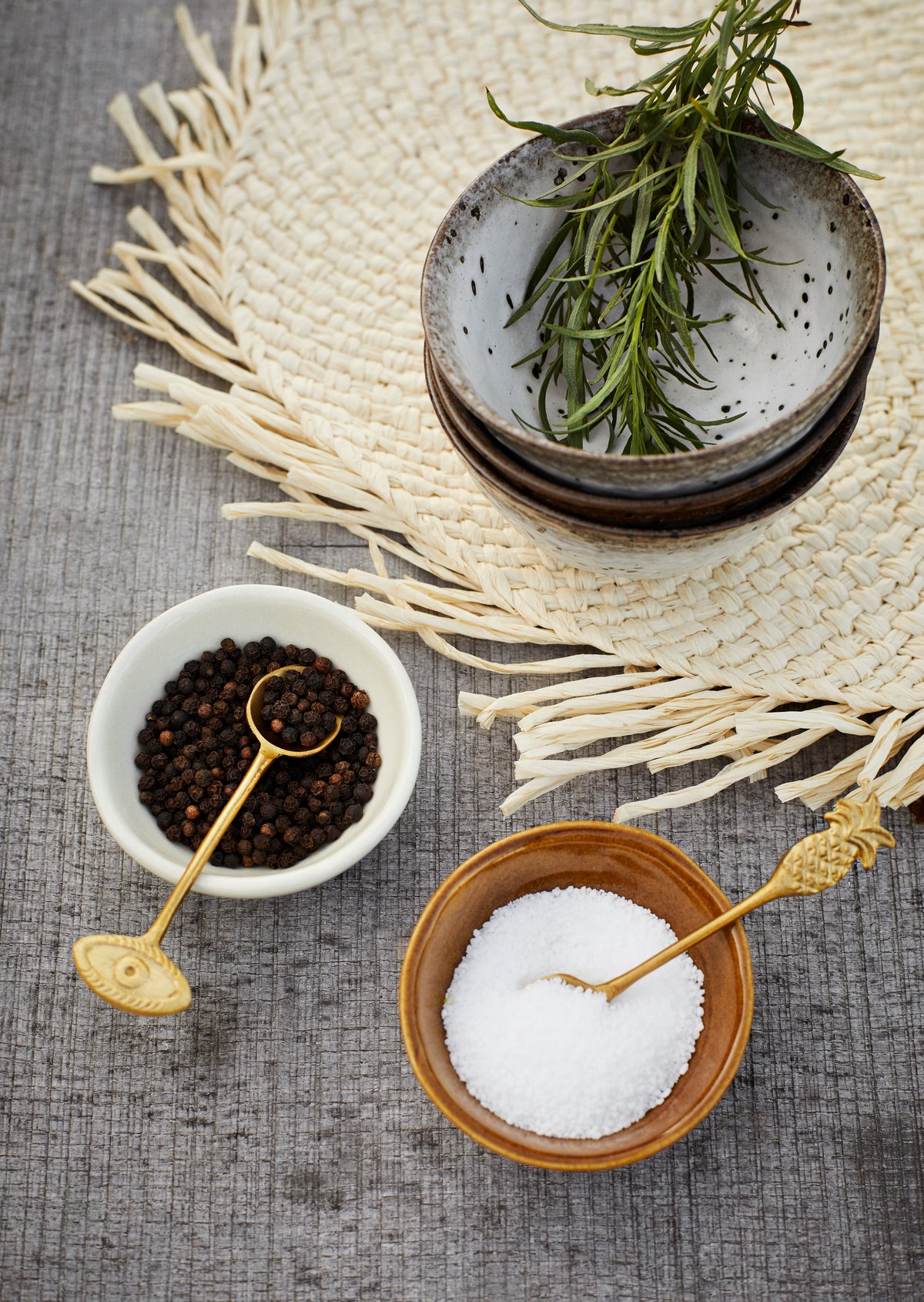 small reactive glaze stoneware bowl filled with fresh herbs on woven placemat
