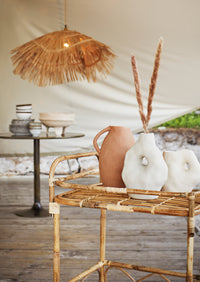 small reactive glaze stoneware bowl filled with fresh herbs on woven placemat
