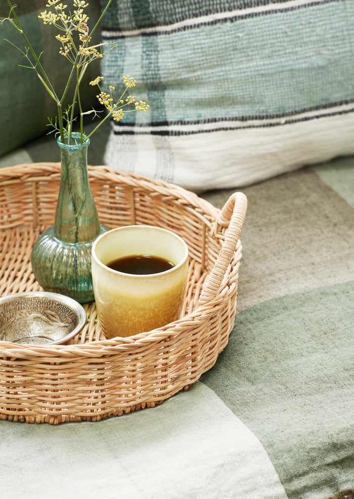 multi-coloured stoneware cup on a breakfast tray with Nordic textiles for relaxed mornings
