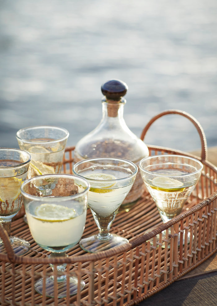 hammered wine glasses filled with drinks styled on a tray for outdoor entertaining
