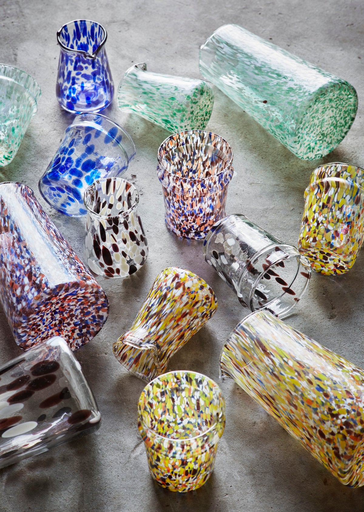 assorted handmade glass jugs and tumblers in colourful recycled glass
