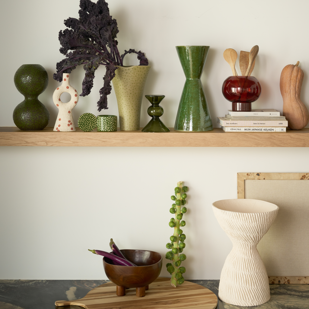 Urban Nature Culture pieces styled across two wooden shelves