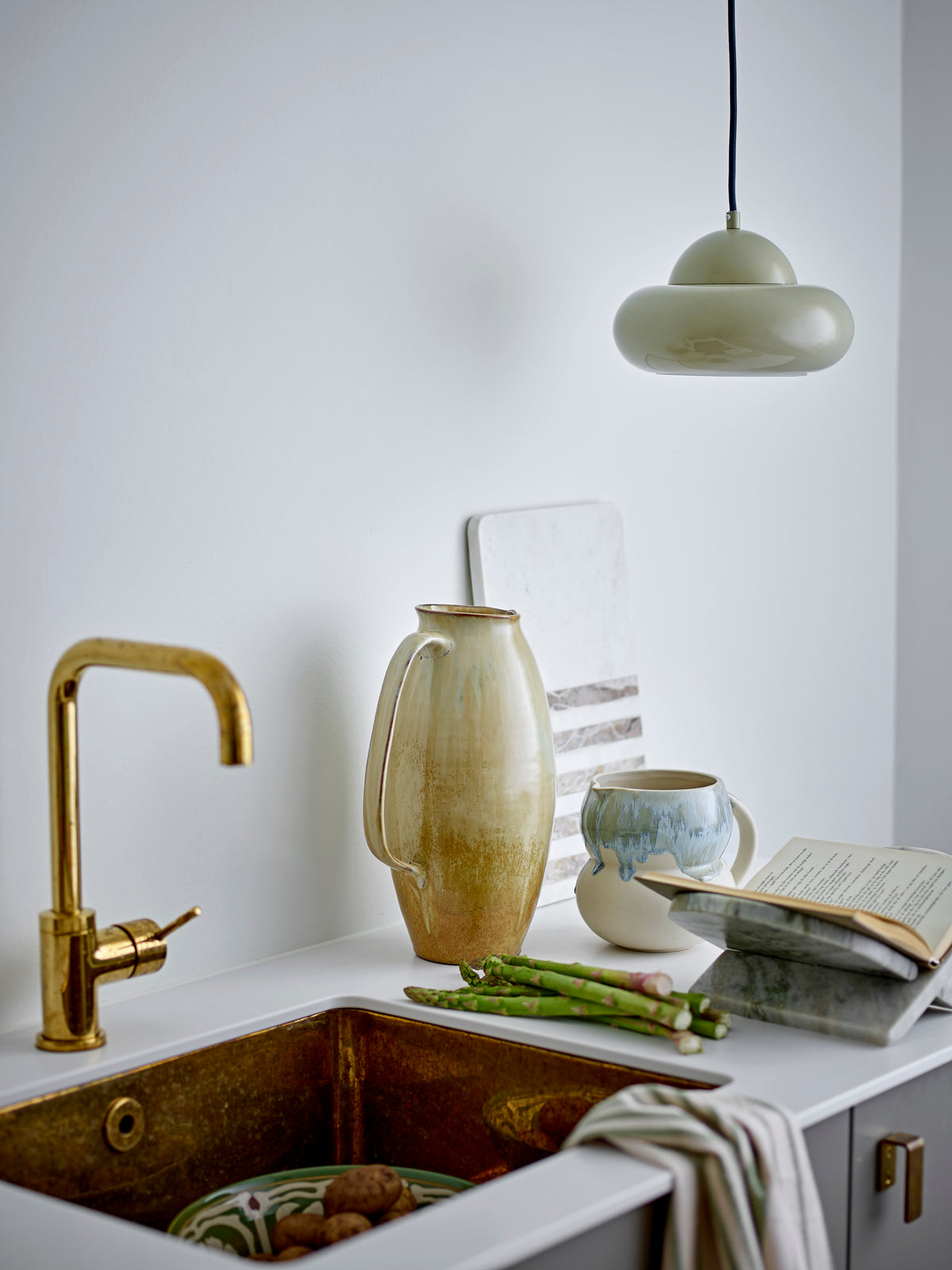 Sculptural stone magazine rack styled in Nordic minimalist living room